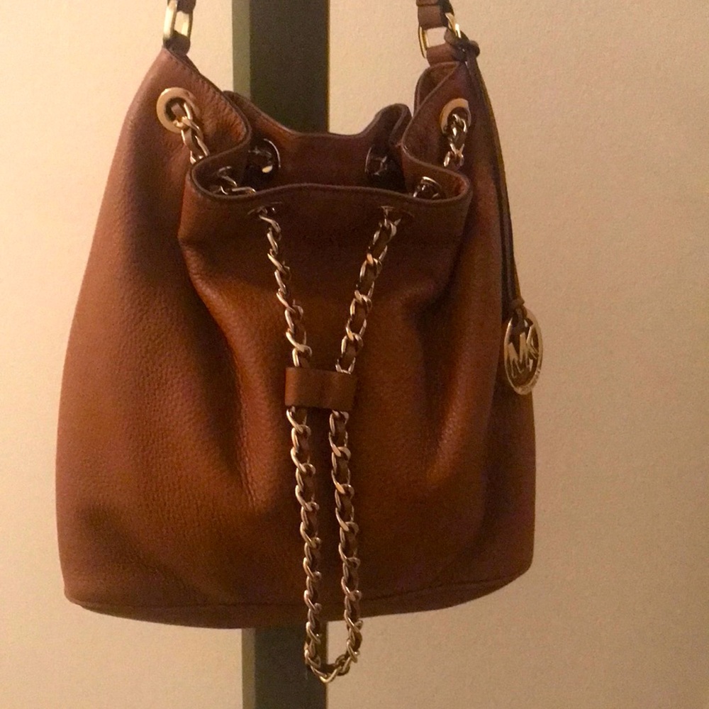Michael Kors brown pebbled shoulder bucket bag.